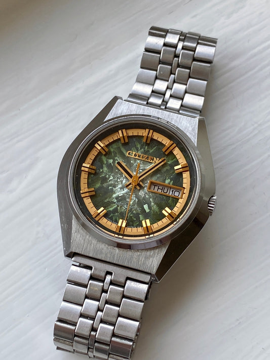 Vintage Citizen Automatic watch with a green marbled dial, gold markers, day-date feature, stainless steel bracelet, and 6501 movement