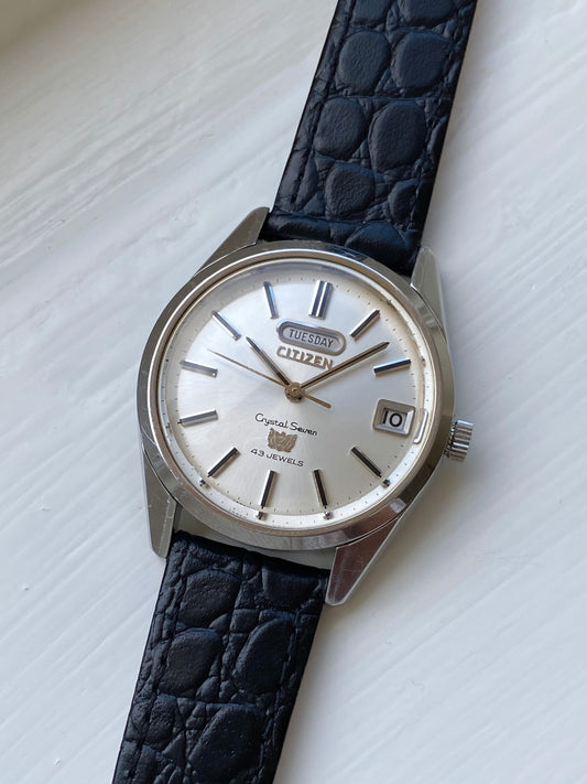 Vintage Citizen Crystal Seven watch with champagne dial and day/date feature on a leather strap, front view